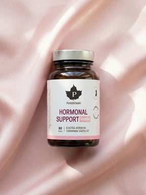 Puhdistamon Hormonal Support purkki vaalenpunaisen kankaan päällä